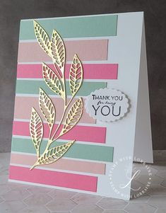 a handmade thank you card with gold foil leaves on pink, green and blue stripes