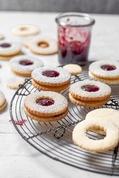 some cookies and jam are on a cooling rack