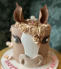 a birthday cake decorated with a horse's head and flowers