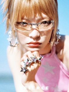 a young woman with glasses and star decorations on her arm