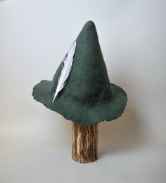 Snufkin Hat. Tom Bombadill's Hat Hand felted Snufkin cosplay hat. Hat in beautiful forest green color.  Great gift for Moomins fan. I make my hats using one of the oldest fiber production technique known to mankind - hand wet-felting. I don't use steam, glue or any other stiffeners or stitching - just pure wool, warm water, olive oil soap and the power of my hands.   |Feather is not included| It is not only decorative costume hat - you can wear it daily! Felt is a very durable material. It's win Snufkin Hat Diy, Adjustable Flat Brim Costume Hat, Adjustable Green Themed Hat, Adjustable Themed Green Hat, Green Brimmed Winter Costume Hats, Fitted Hat With Curved Brim For Cosplay, Fitted Curved Brim Hat For Cosplay, Adjustable Felt Hat With Short Brim For Costume, Themed Fitted Hat For Cosplay