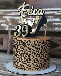 a leopard print cake with a high heel shoe topper on it's side