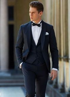 a man in a tuxedo is walking down the street