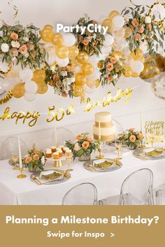 a birthday party with balloons, cake and flowers on the table in front of it