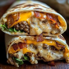 two burritos with meat and cheese are stacked on top of each other