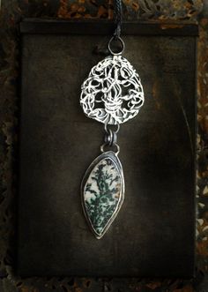 'Recompense' is hand sculpted of sterling silver, fine silver, and an Indonesian dendritic agate. After the stark chill of winter, the first blooms of spring are a loud burst of life. Spring seems to be nature's way of apologizing for the rest of winter - a recompense filled with color, bird song, fresh breezes, and new life. I sculpted this piece in tribute to nature's recompense. A visual ode to nature's bounty. 'Recompense' is a reminder that though rest is required, after that quiet comes th Emerald Green Necklace, Jewelry Emerald, Bird Song, Gift For Gardener, Silver Link Chain, Nature's Bounty, Spring Jewelry, Dendritic Agate, Agate Necklace