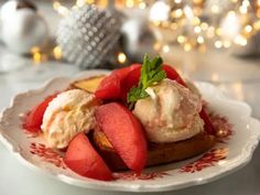 a white plate topped with fruit and ice cream