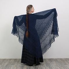 a woman wearing a blue shawl with braids