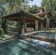 a house with a pool in front of it surrounded by greenery and flowers on the roof