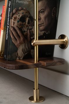 there is a book shelf with books on it and a skull in front of it