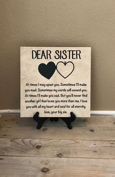 a sign that says dear sister with two hearts on the front and back of it