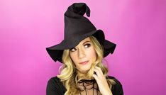 a woman wearing a black witches hat on top of her head