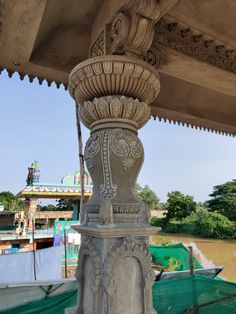 an ornately decorated pillar in front of a building