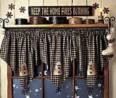 a window with some decorations on it and a sign above the window that says keep the home fires burning