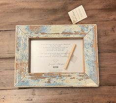 an old frame with a pen on top of it next to a piece of paper