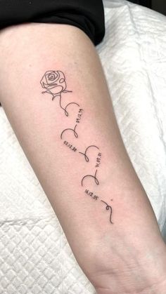 a woman's arm with a rose tattoo on it