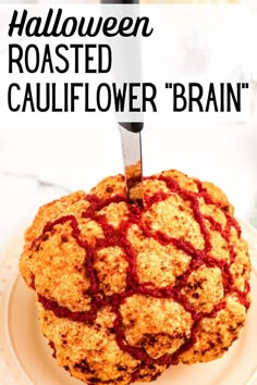 a close up of a cake on a plate with the words halloween roasted cauliflower brain