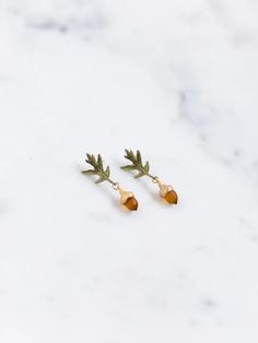 This beautiful Pin Oak Jewelry is inspired by the majestic grandeur of the oak tree, representing strength, wisdom and healing. Crafted by hand, like miniature wearable sculptures, this collection is a timeless testament to beauty and power. Oak Jewelry, Acorn Caps, Miniature Jewelry, Acorn Jewelry, Earring Pins, Writer Gifts, Cast Glass, Heirlooms Jewelry, Anne Of Green