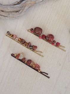 Add a little creative spin to fashionable looks with our upcycled bobby pins!  Great for all hair types and styles.  Spruce up your up do or tie back those lose locks with a set of our beautiful gemstone hair pins. Each bobby pin is handmade by us, using a beautifully polished gemstone beads and embellished with small glass, wood or metal beads.  Each pin is unique and one of a kind! This listing includes your selection of one of the bobby pins shown.  The pins are on a 2" long metal bobby pins.  Very stylish a fun natural hair accessory. Choose from: 1- Red Jasper 2- Carnelian 3- Gold Stone 4- Buy Three and Save - List your selections in the Customized Box!   Embellished hair pins make a snazzy gift idea.  Our pins will arrive on a cute card and in a box ready for gift giving. For more na Decorative Bobby Pins In Hair, Hair Grips Bobby Pins, Embellished Bobby Pins, Pink Bobby Pins, Gemstone Bobby Pins, Gemstone Hair, Natural Hair Accessories, Stocking Stuffers For Her, Bead Hair Accessories