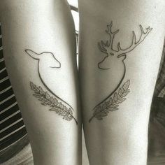 two people with tattoos on their legs that have deer heads and leaves tattooed on them