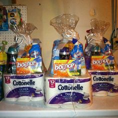 three bags of toilet paper sitting on top of a counter next to each other in front of a refrigerator