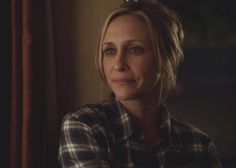 a woman in plaid shirt looking off into the distance