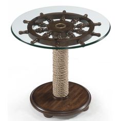 a glass and wood table with rope on it's base, in the shape of a ship wheel