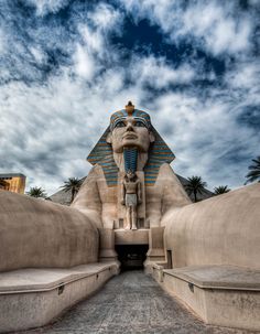 the entrance to an egyptian style building with a sphinx head on it's face