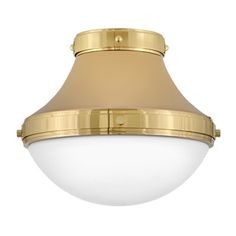 a light fixture with a white glass shade on the bottom and gold trim around it