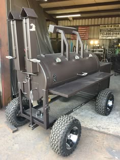 a large metal object with four wheels in a garage