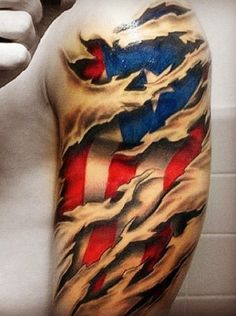 a man's arm with an american flag tattoo on it, holding a cell phone