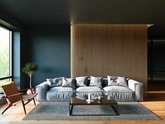 a living room filled with furniture next to a large window and wooden flooring on the walls