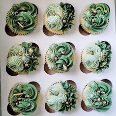 twelve cupcakes decorated with green frosting and gold decorations