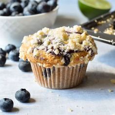 a muffin with blueberries and lime on the side