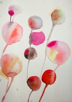 three watercolor flowers on a white paper with red and pink petals in the center