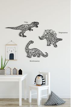 three dinosaurs are shown on the wall in this children's room with white walls