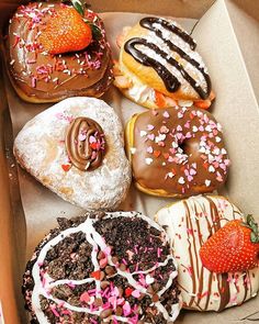 a box filled with lots of different flavored donuts