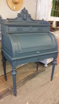 an old blue piano sitting on top of a wooden floor