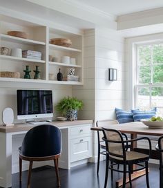 a table with chairs and a television in a room