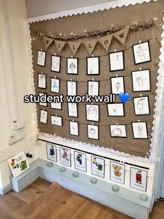 a bulletin board with pictures on it and some lights hanging from the wall behind it