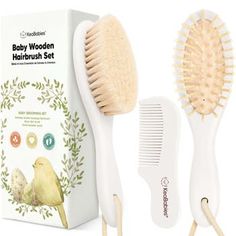 the baby wooden hairbrush set is next to its box and it's brush