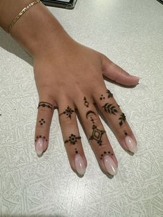 a woman's hand with tattoos on it