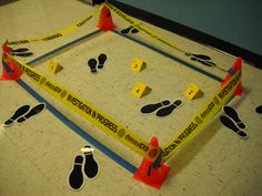 there are many caution tape on the floor with feet and ankles around them that have been taped together