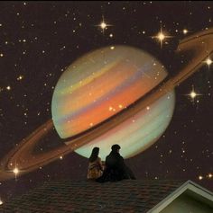 two people sitting on top of a roof looking at the sky with saturn in the background