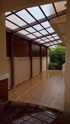 an empty room with hard wood floors and glass doors on the outside wall is shown