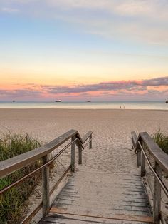 stairs lead down to the beach at sunset