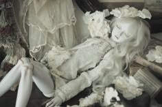 a white doll laying on top of a table