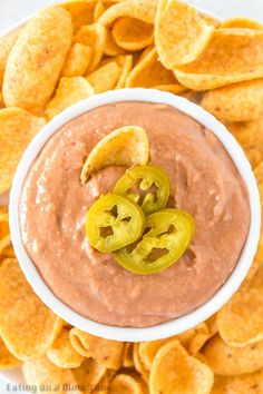 a white bowl filled with chips and dip