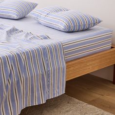 a bed with blue and white striped sheets