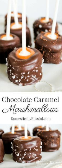 chocolate caramel marshmallows are arranged on a white platter with candles